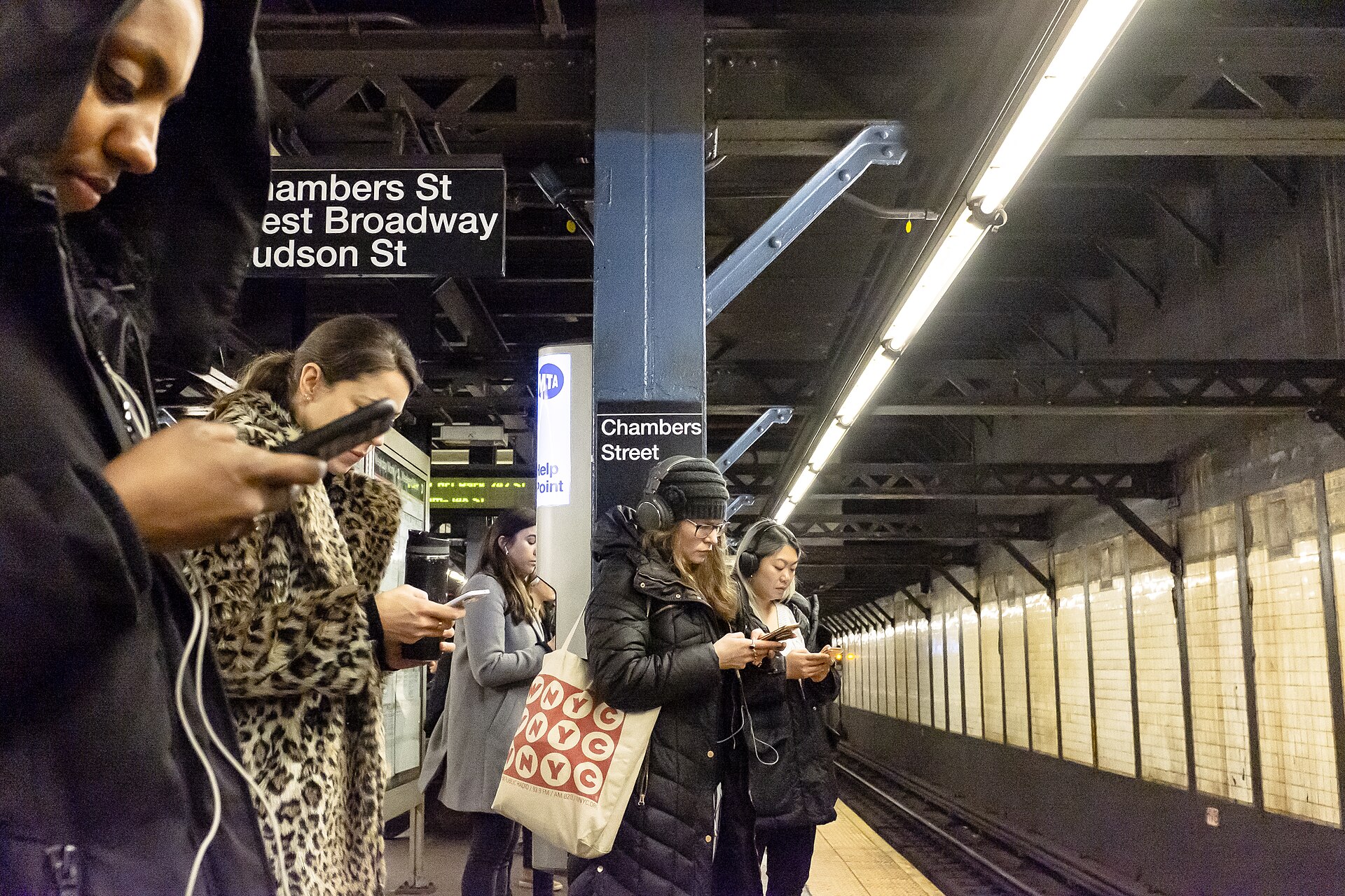 people using smartphones street